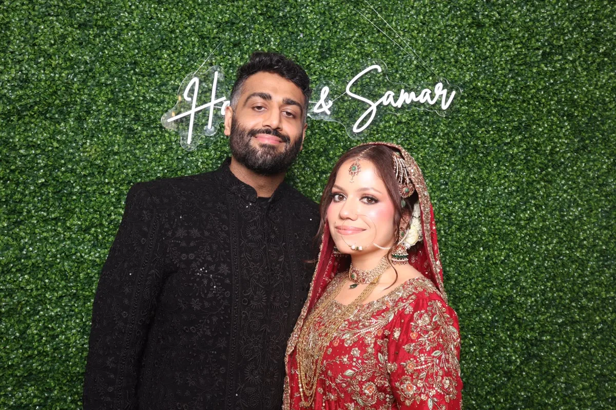 Clutch City luxury booth with greenery backdrop at Houston event